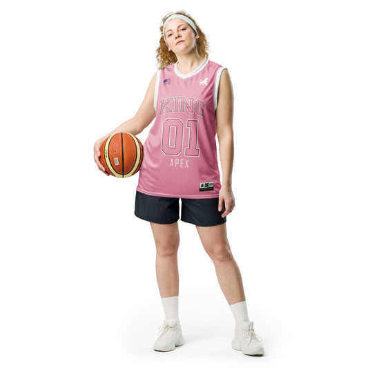 Female model wearing pink KING basketball jersey Lioness edition with minimalist lioness logo