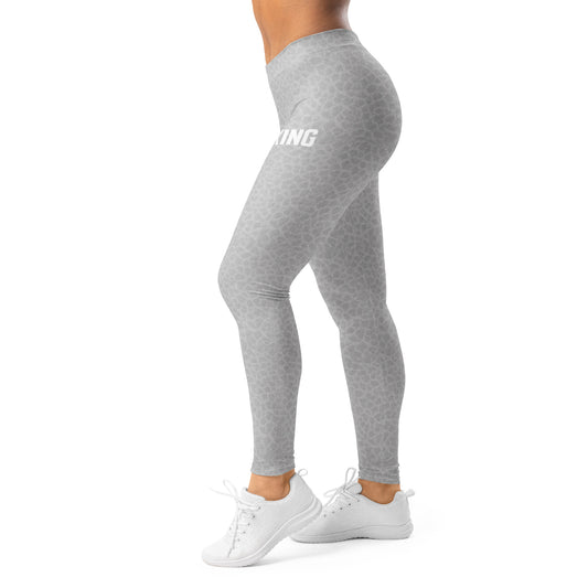 Side view of woman wearing KING Lioness gray camo leggings during movement