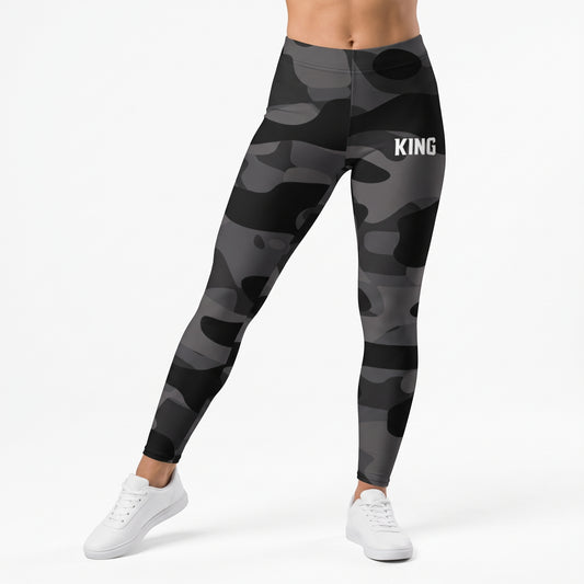 Model walking in KING APEX Lioness black and gray Shadow Camo workout leggings for women.