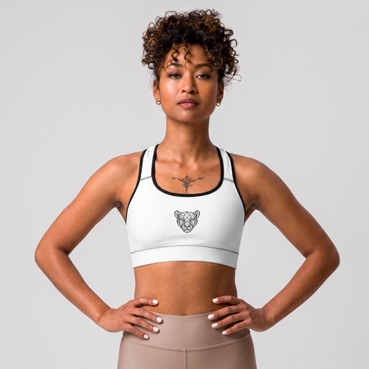 Female model wearing the KING Lioness Sports Bra in white with black piping.