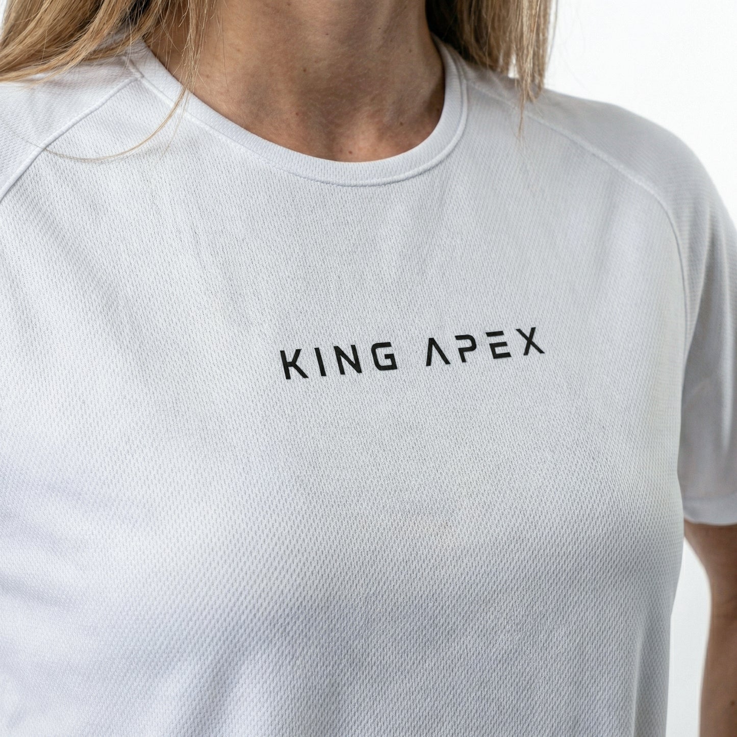KING APEX Core Sports Jersey White – minimal athletic performance t-shirt closer on her chest focusing on the logo.