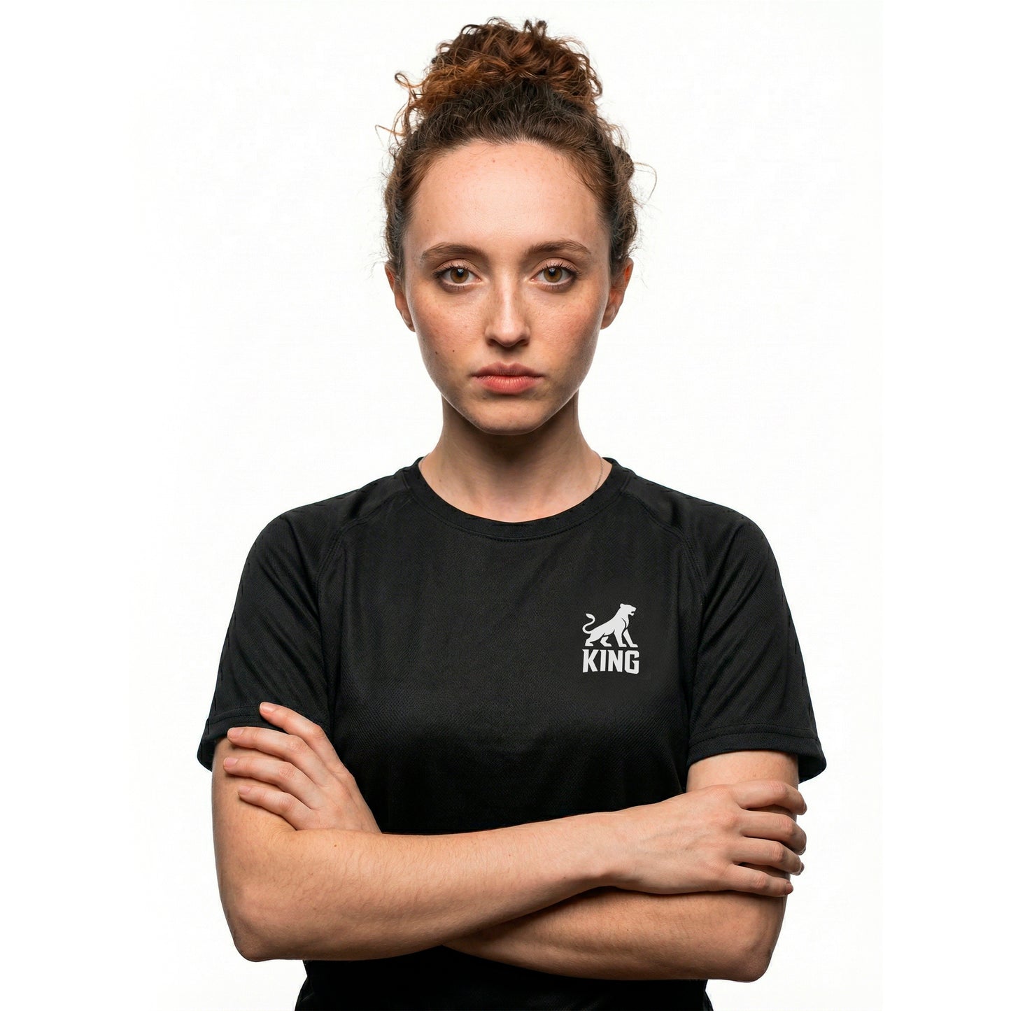 Woman wearing KING APEX black sports jersey with minimal lioness logo on chest