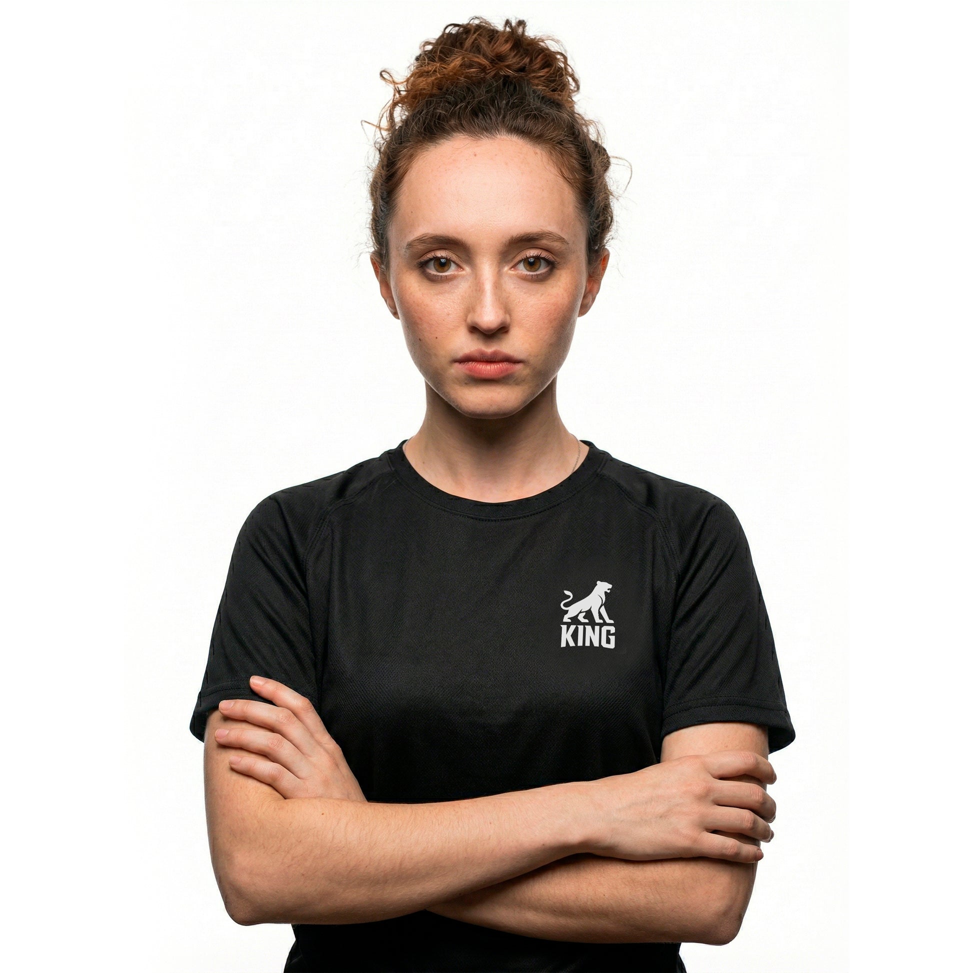 Woman wearing KING APEX black sports jersey with minimal lioness logo on chest