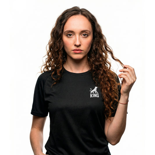 Female model wearing KING APEX black athletic sports jersey with minimal lioness logo