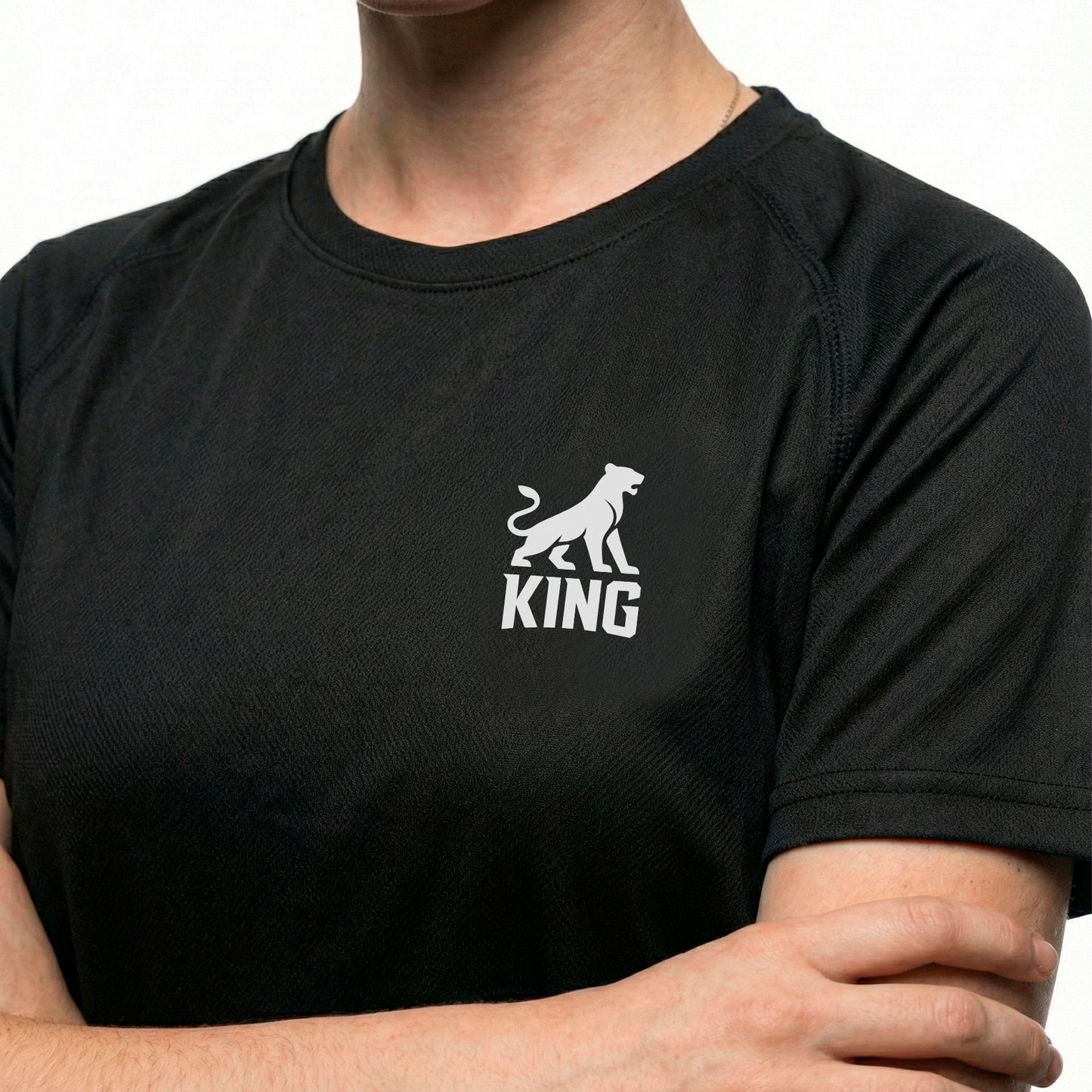Close-up of minimal lioness logo on KING APEX black performance sports jersey