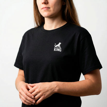 Close-up of minimal lioness logo on KING APEX black sports t-shirt worn by female model