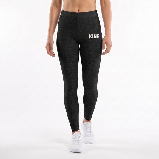 Model wearing KING APEX Lioness Black Heather leggings with a white KING thigh logo and white sneakers, walking toward the camera.