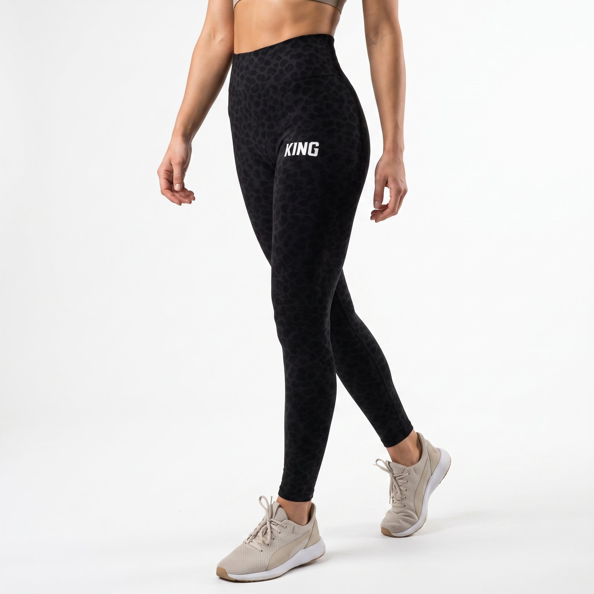 Woman wearing KING APEX Lioness Stealth Midnight Black high-waisted leggings