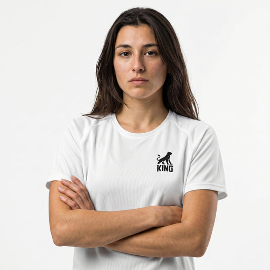 Female model wearing KING APEX white athletic sports jersey with minimal lioness logo
