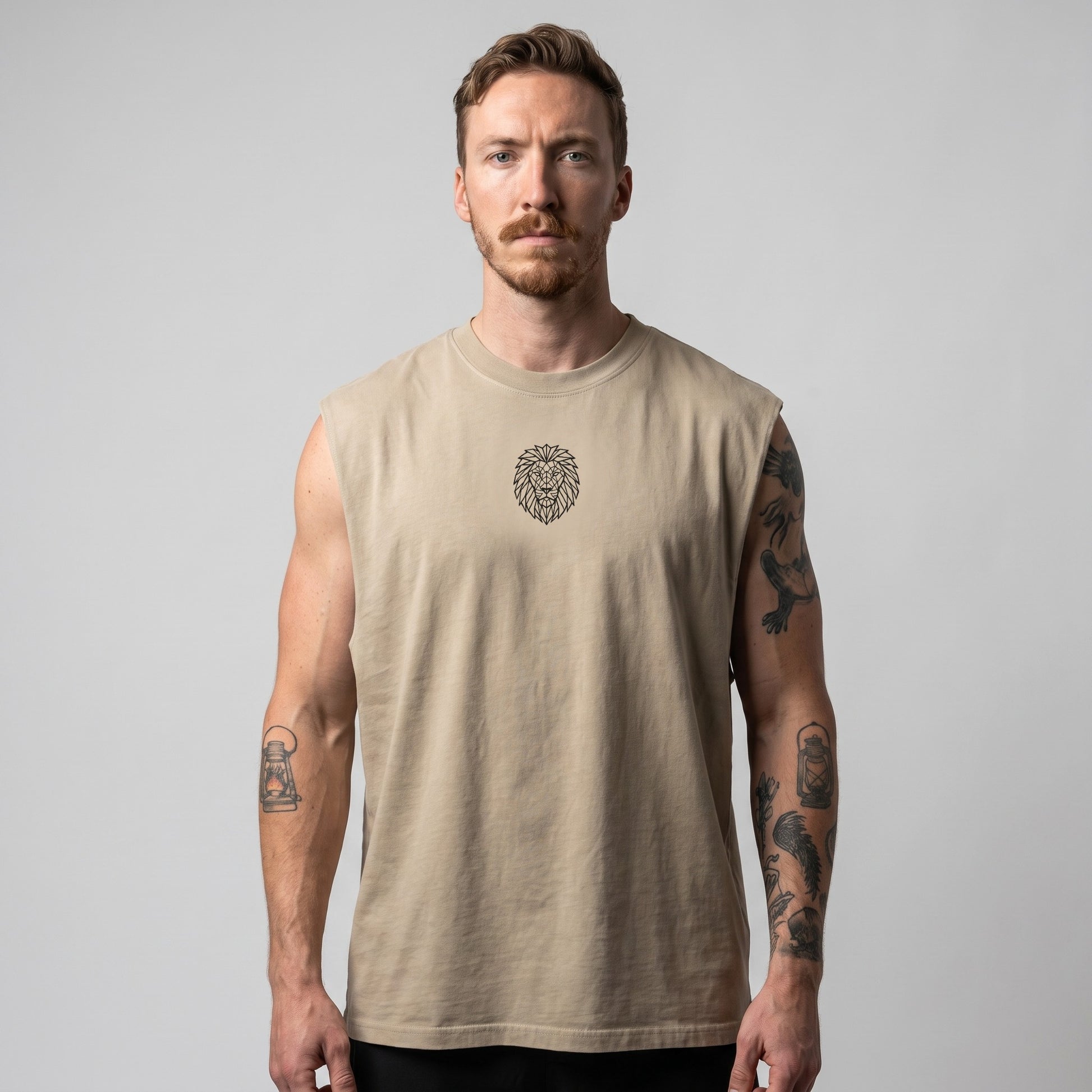 Male model wearing the KING APEX Men's Heavy Faded Tank in sand, featuring a relaxed boxy fit and geometric lion chest logo.