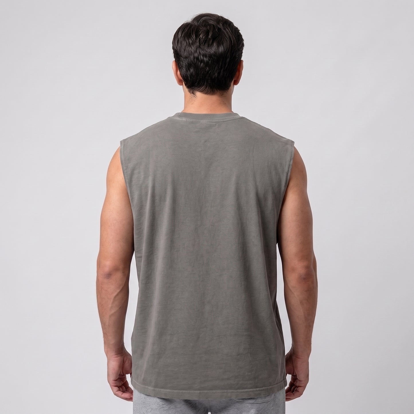 Male model wearing the KING APEX Men's Heavy Faded Tank in Stone Grey, full back view.