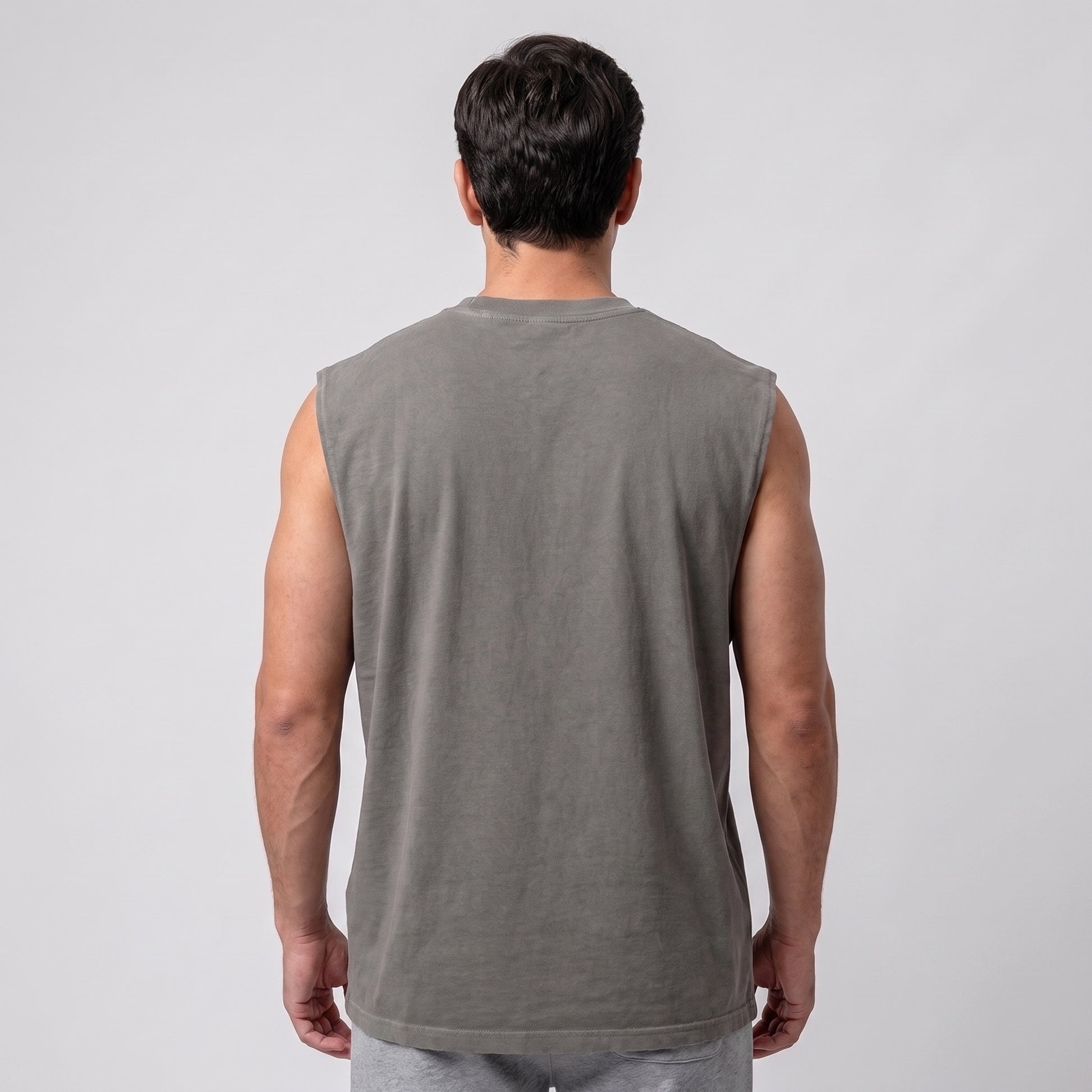 Male model wearing the KING APEX Men's Heavy Faded Tank in Stone Grey, full back view.