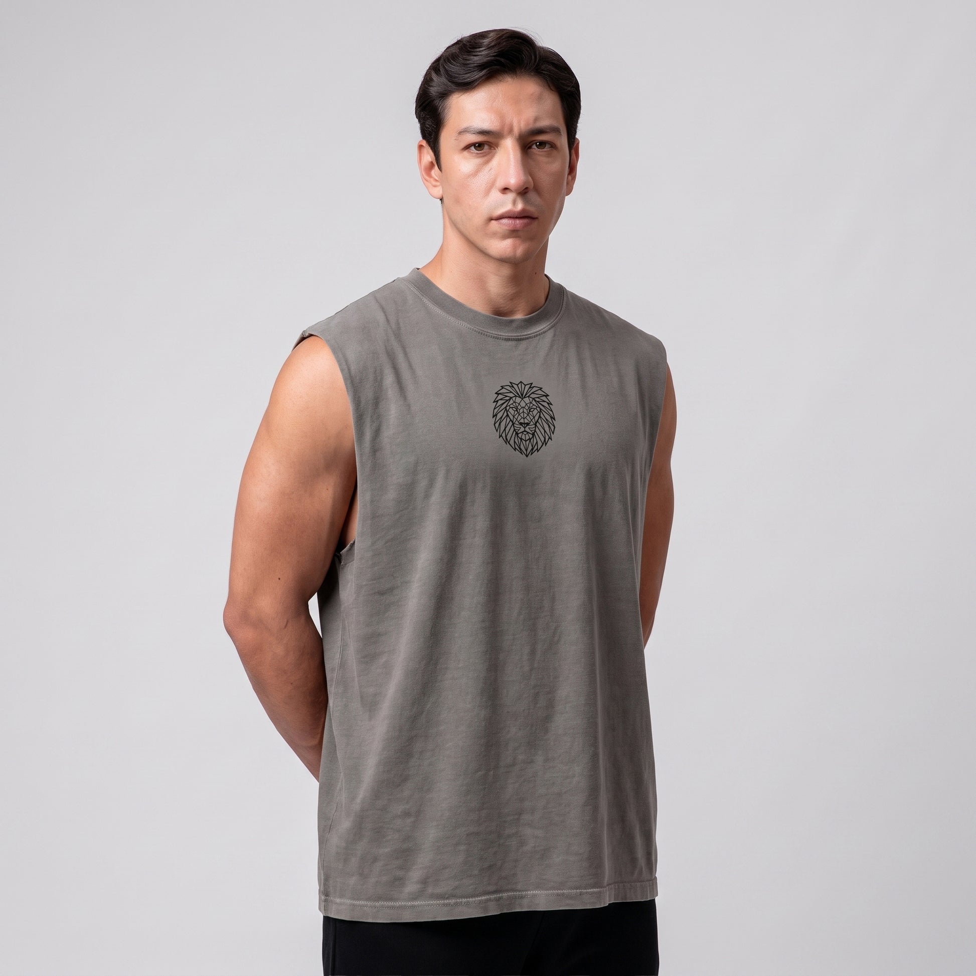 Male model wearing the KING APEX Men's Heavy Faded Tank in Stone Grey, side view with hands behind his back.