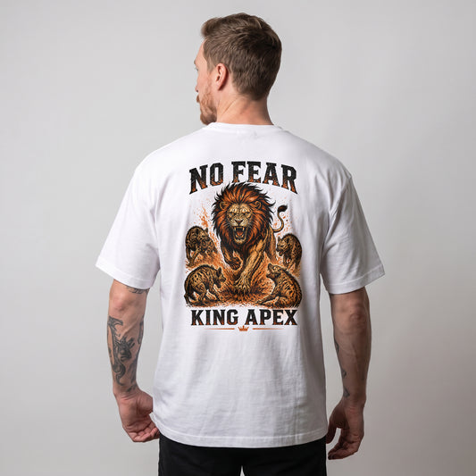 Male model wearing the white KING APEX No Fear oversized T-shirt, showing the orange and black lion graphic on the back.