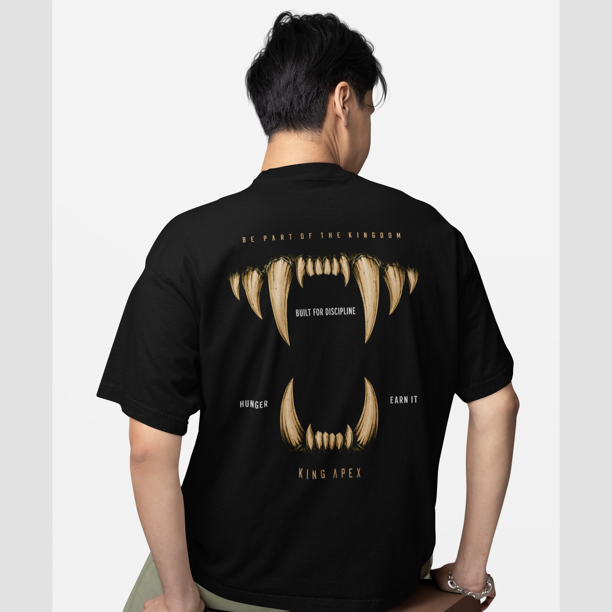 model wearing KING APEX oversized black t-shirt Hunger Edition with fang design