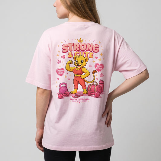 Angled rear view of the KING APEX Soft Pink oversized T-shirt with a cartoon lioness, hearts and gym equipment.