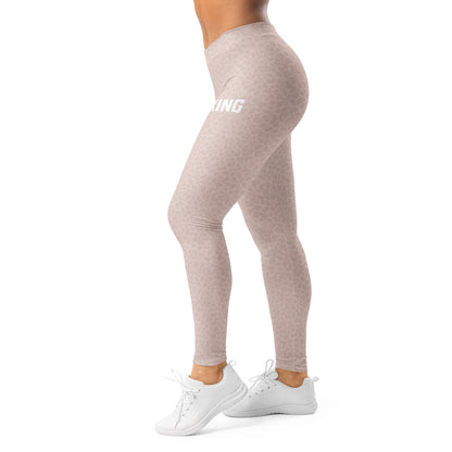 Side view of woman wearing KING Lioness rose camo leggings in motion