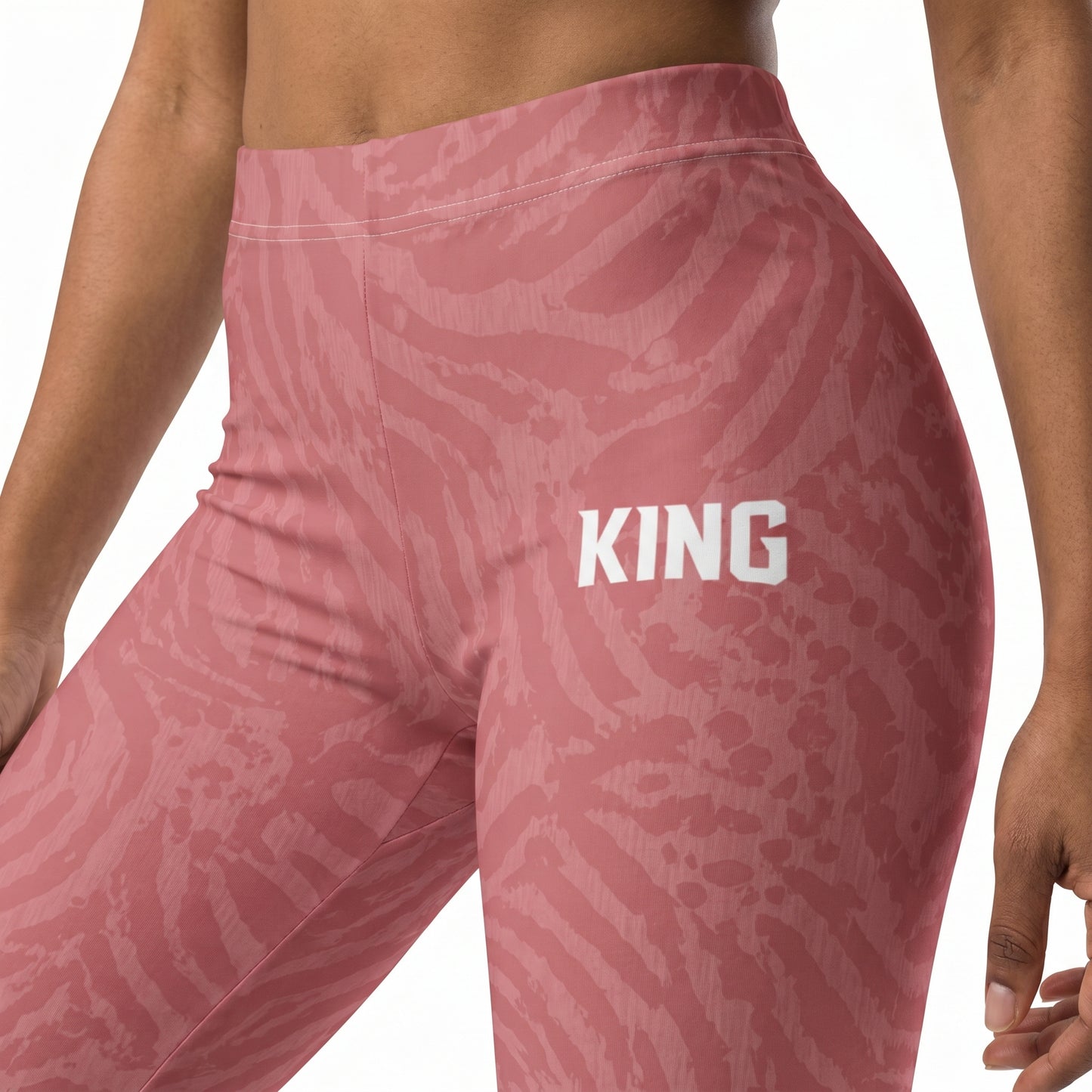 Close-up of KING logo on soft rose performance leggings with jacquard-inspired texture