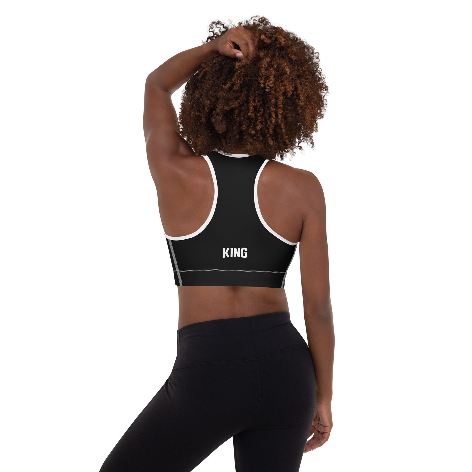 Black Lioness sports bra with white piping – back view showing KING logo.
