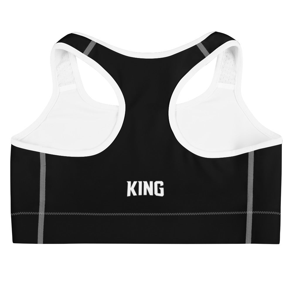 Flat product mockup of black Lioness sports bra with white piping – back with KING logo.