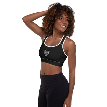Black Lioness sports bra with white piping and geometric lioness emblem – left side view.