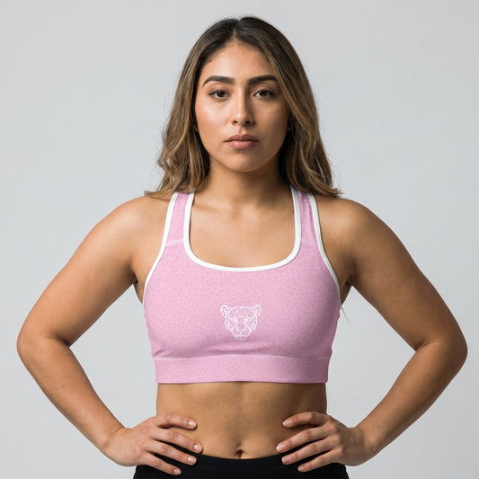Female athlete wearing KING Lioness Sports Bra Rose Scale Edition in pink geometric lioness pattern, front view