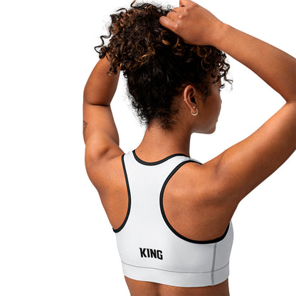 White KING Lioness sports bra with black piping – side view with geometric lioness emblem.
