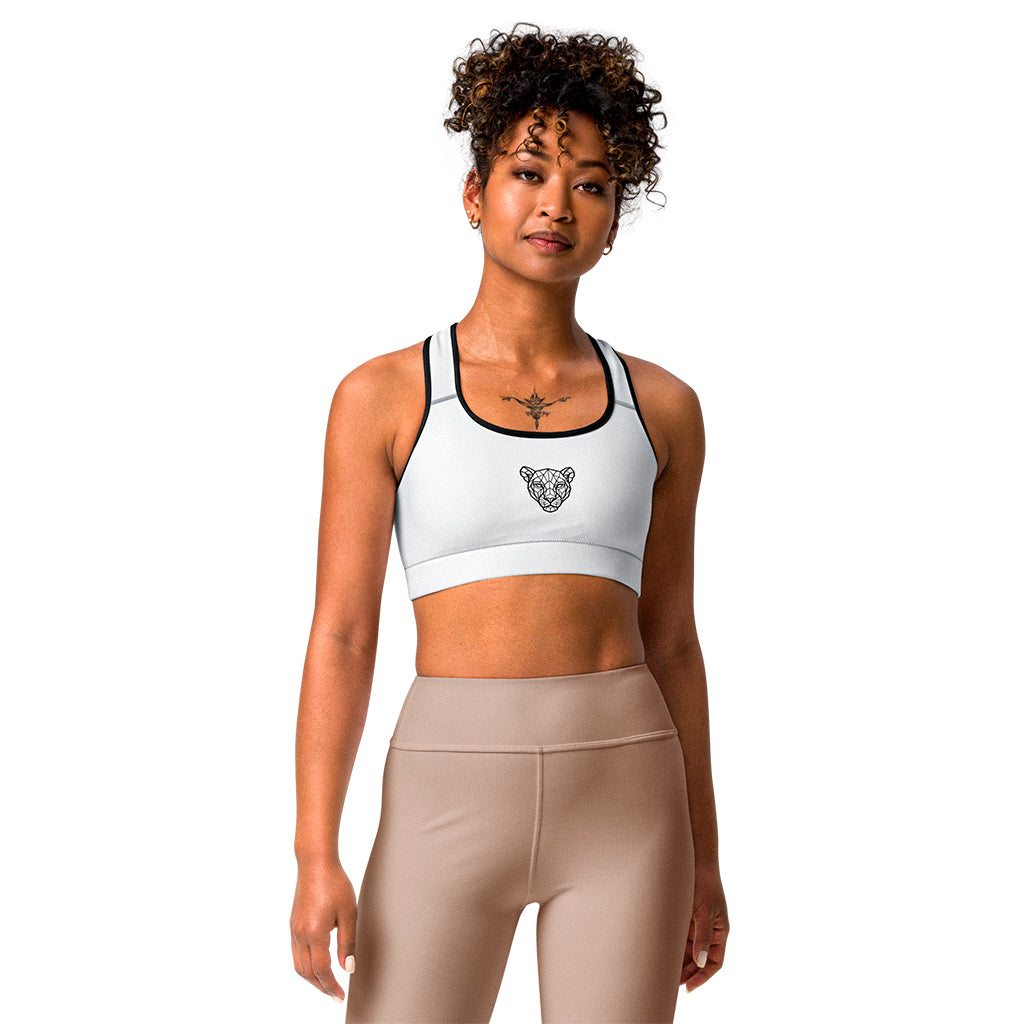 White KING Lioness sports bra with black piping and geometric lioness emblem – front view.