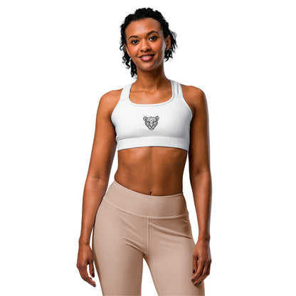 White KING Lioness sports bra with geometric lioness emblem – female model front view.
