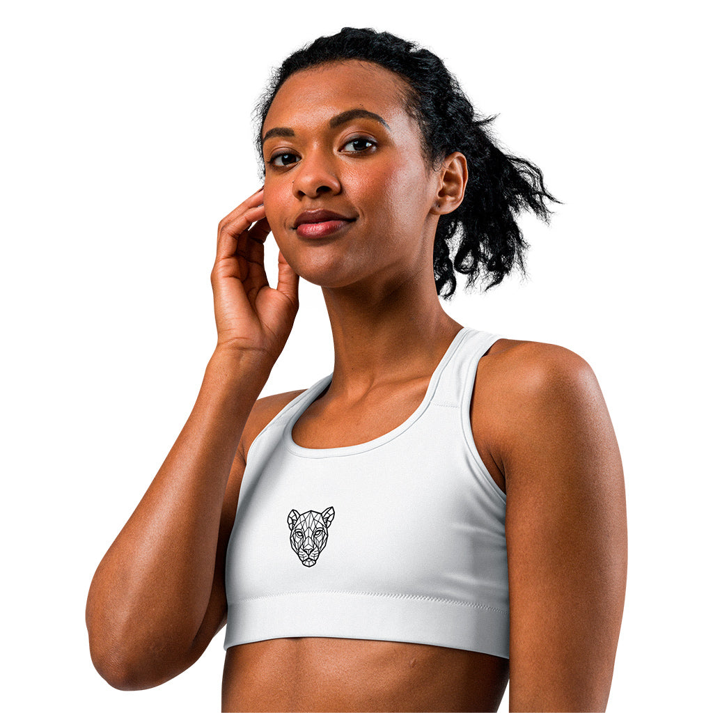 White KING Lioness sports bra – side view with geometric lioness emblem on chest.
