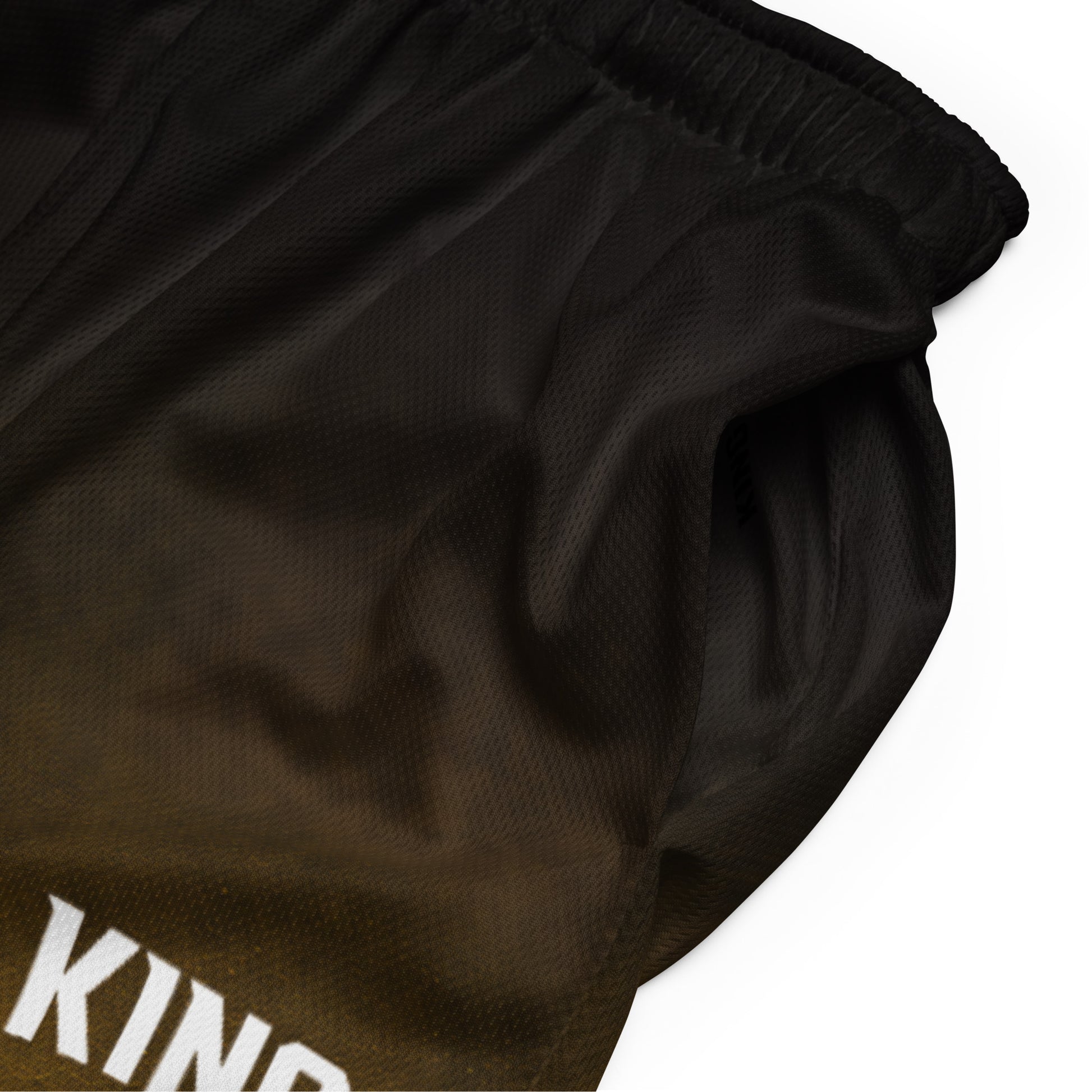Close-up fabric texture of KING Mesh Shorts Gold Fade Edition