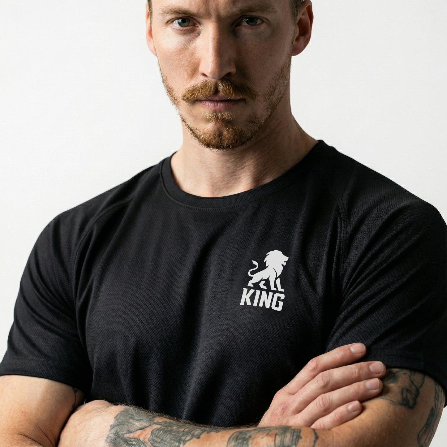 Male model wearing KING Sports Jersey Black with Minimal Lion Chest logo, close front view, premium athletic apparel