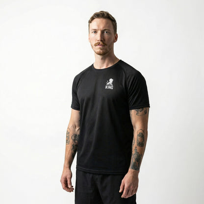 Male model wearing KING Sports Jersey Black with Minimal Lion Chest logo, full body side view, performance sportswear
