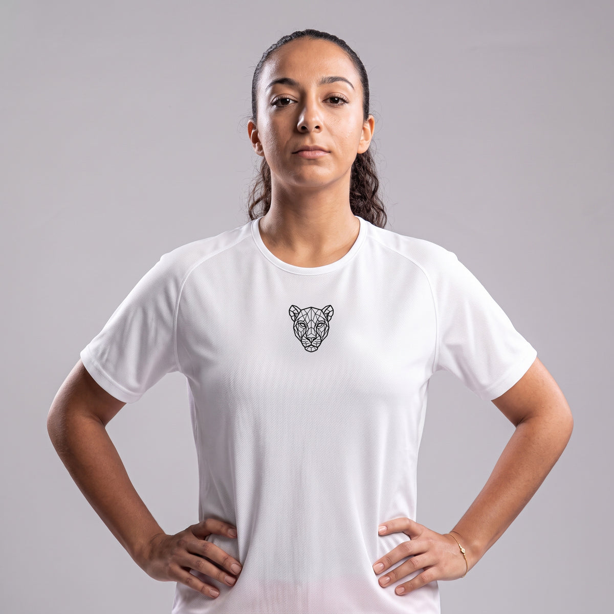 Woman wearing white KING Sports Jersey with geometric lioness chest logo, front view