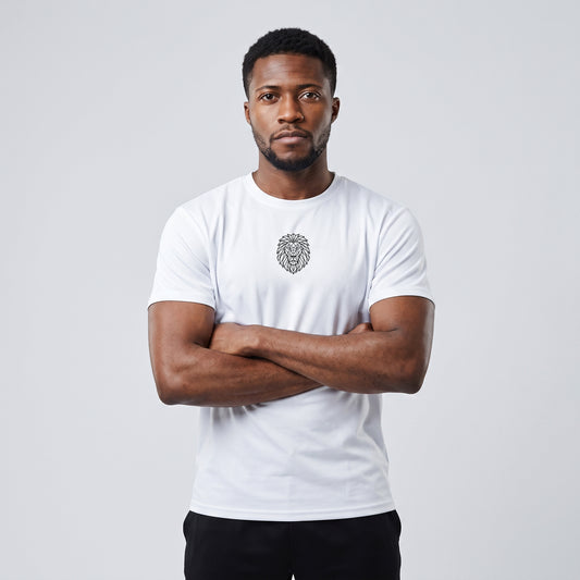 Male model wearing the KING Sports Tee in white with geometric lion chest graphic, front view with arms crossed.