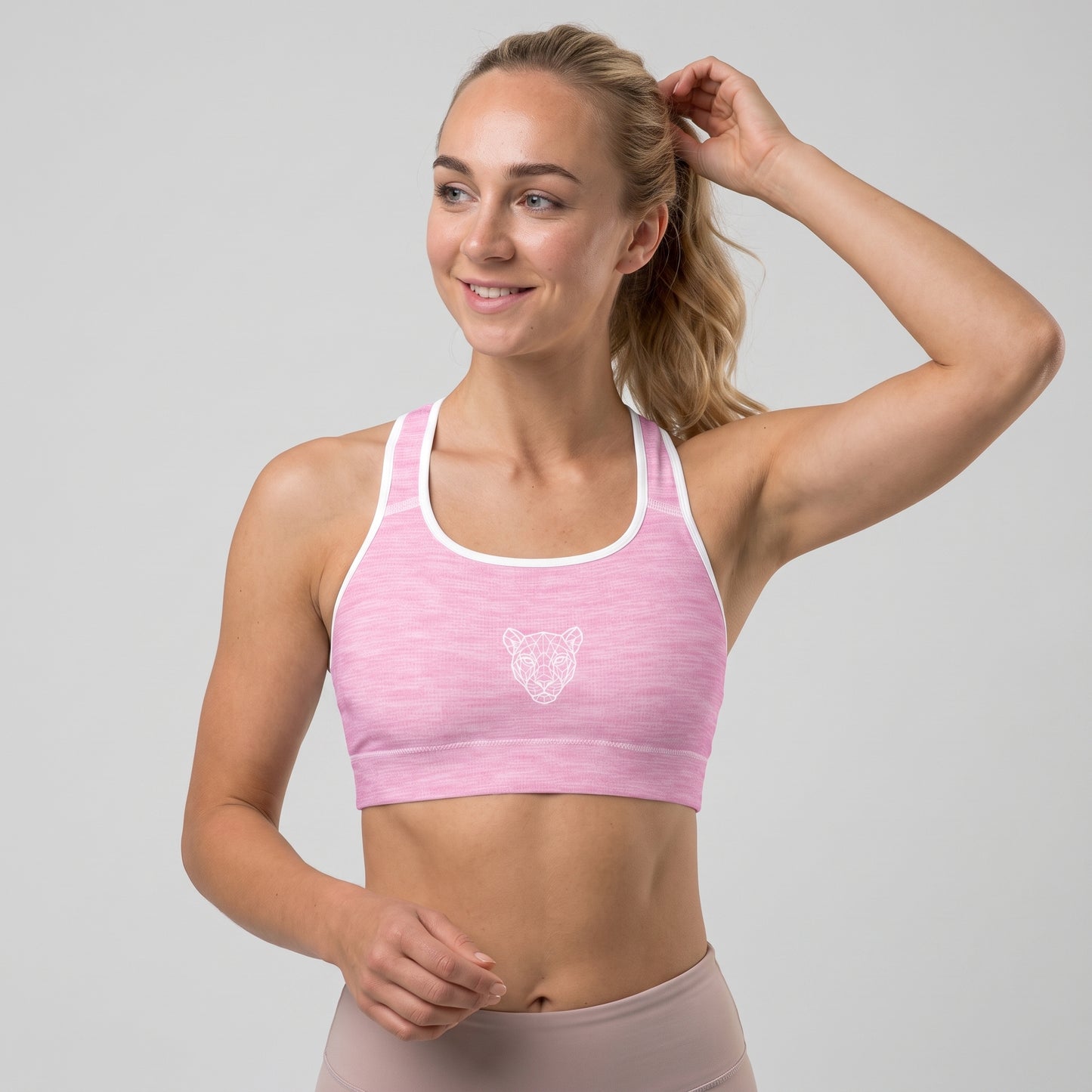 Woman wearing the KING Lioness Pink Padded Sports Bra in a front angled view.