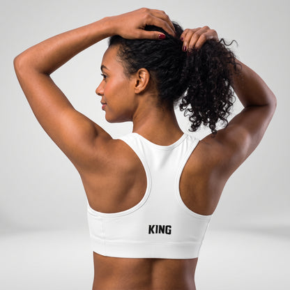 Angled back view of the KING Lioness Sports Bra in black on a female model.