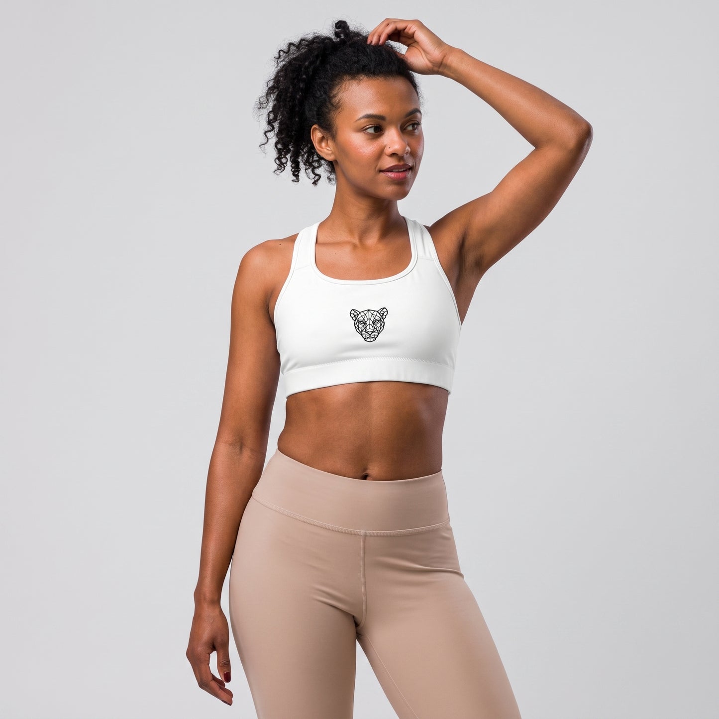 Side view of the KING Lioness Sports Bra in black on a female model.