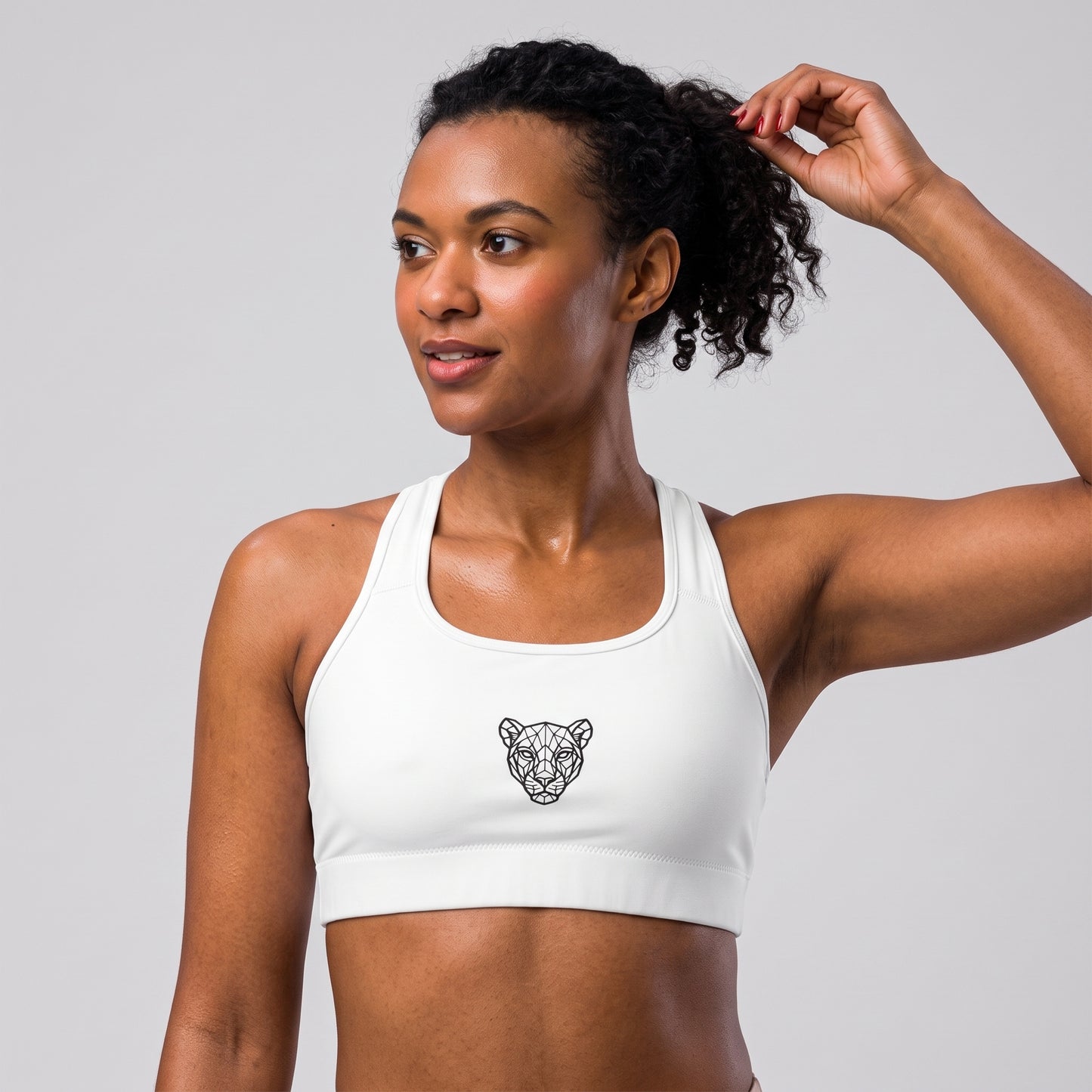 Three-quarter view of the KING Lioness Sports Bra in black on a female model.