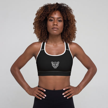 Woman wearing the KING Lioness Sports Bra in black with white piping, front view.