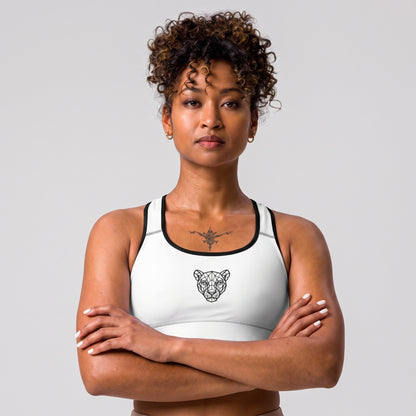 Woman wearing the KING Lioness Sports Bra in white with black piping, front view.