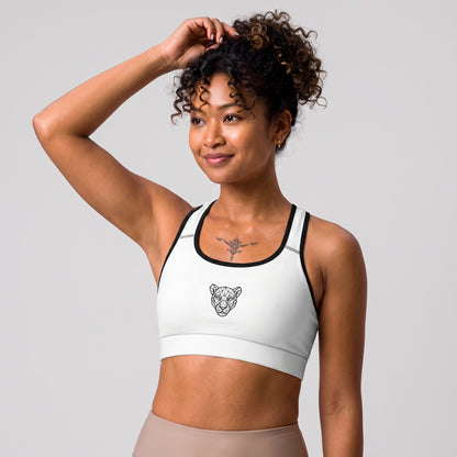 Side view of the KING Lioness Sports Bra in white with black piping on a female model.